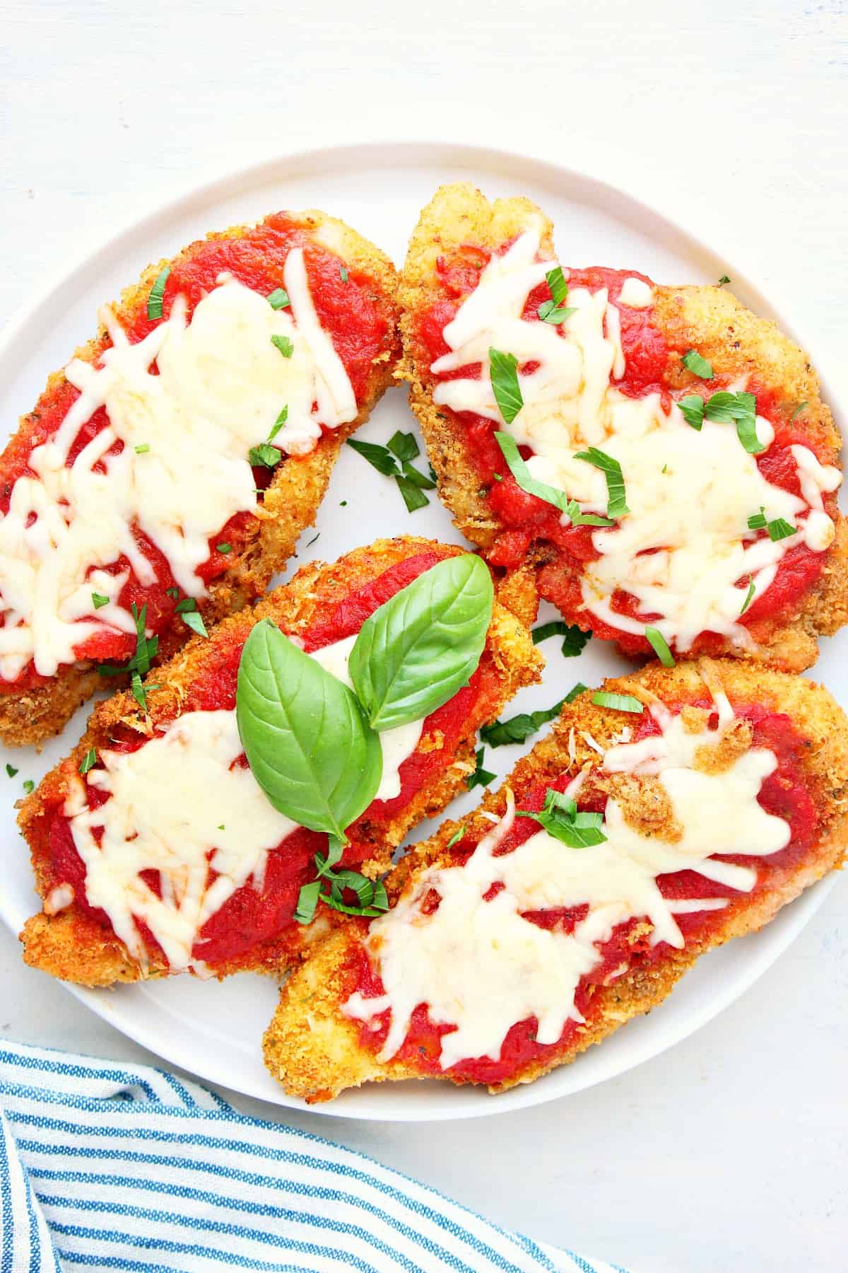 Chicken Parmesan on a white plate.