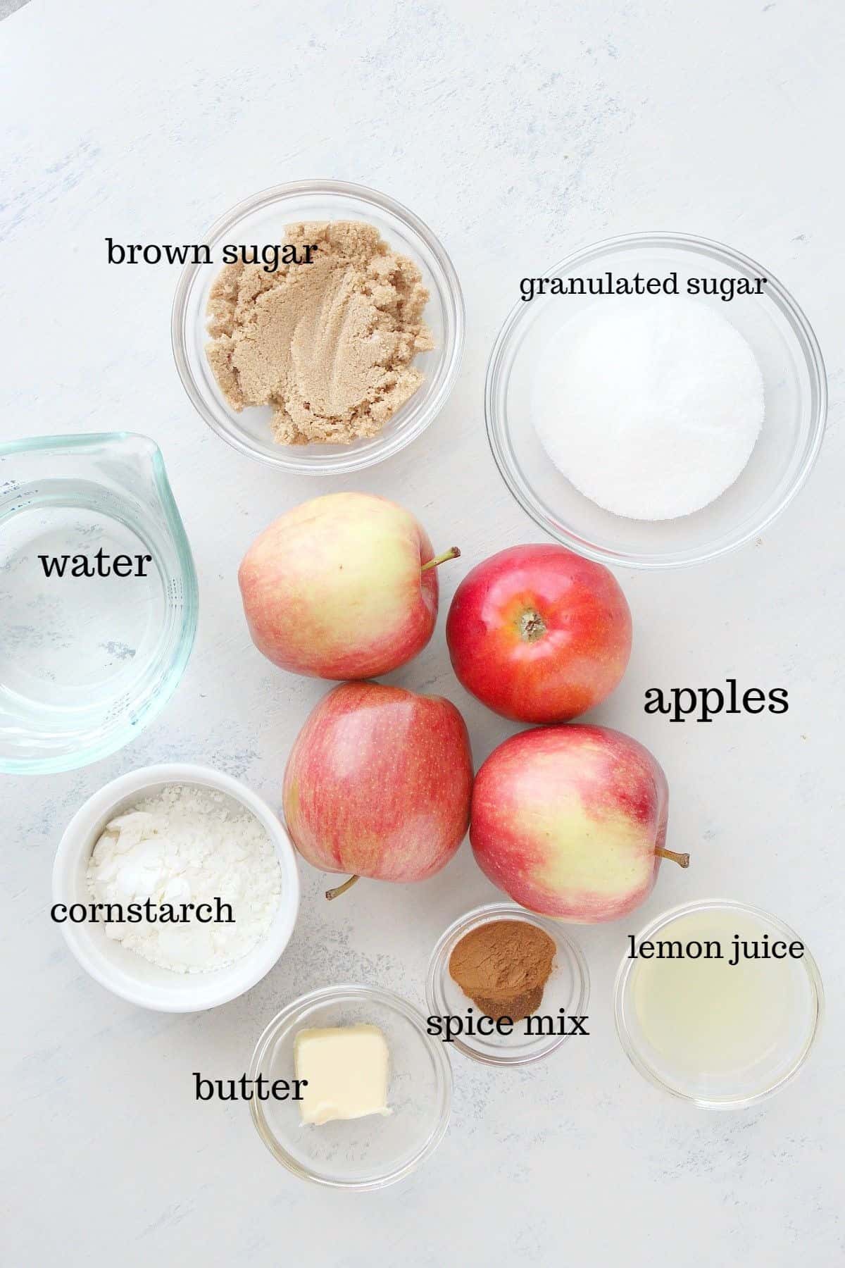 Ingredients for pie filling on a white board.