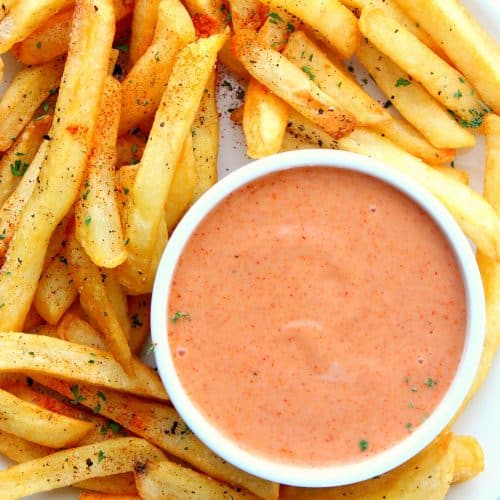 Fry sauce in a ramekin with fries on a plate.