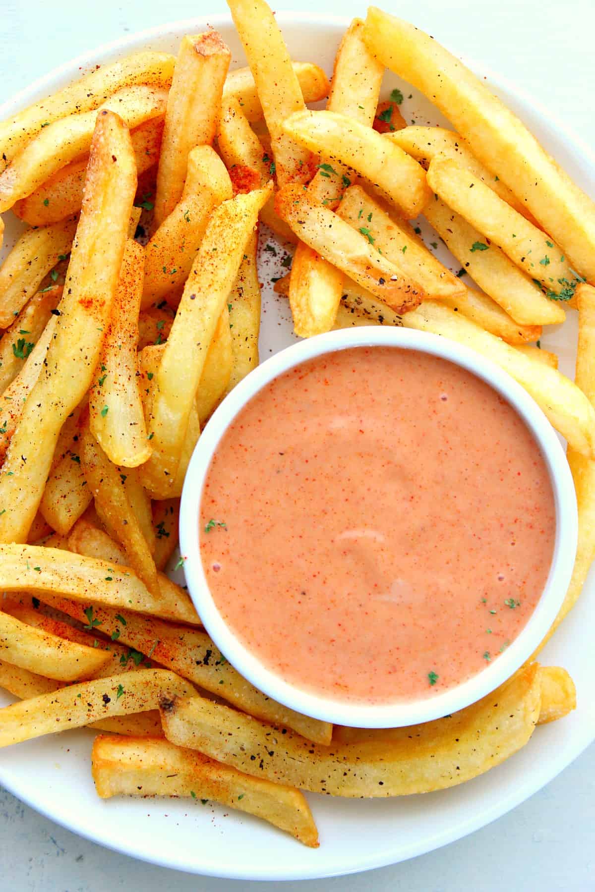 Fry sauce in a ramekin with fries on a plate.