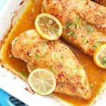 Chicken with lemons in a dish.