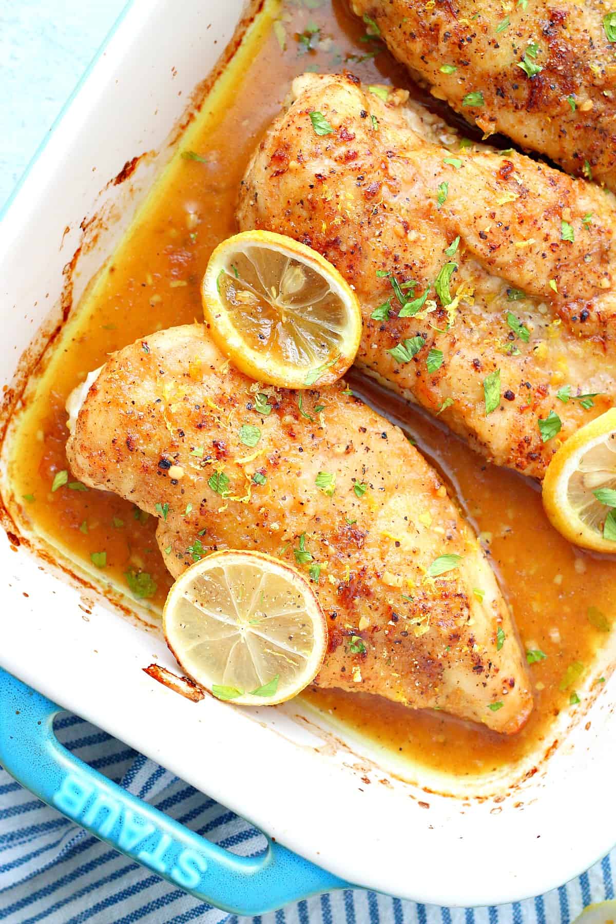 Chicken with lemons in a dish.