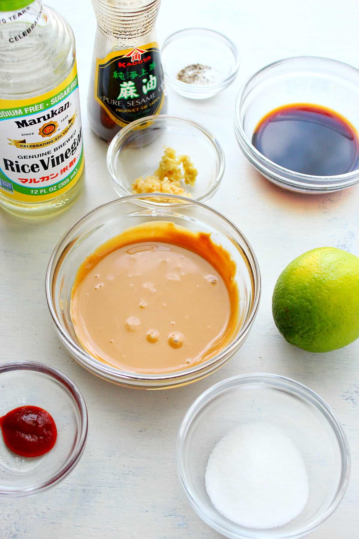 Ingredients for peanut dressing on a white board.