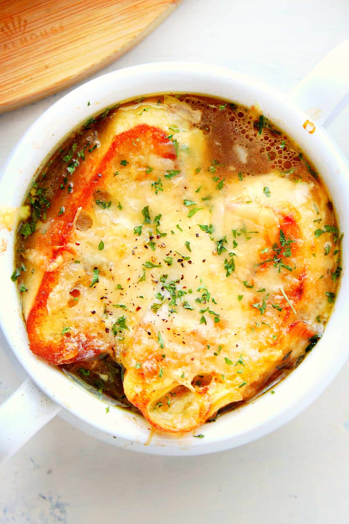 French onion soup with cheesy toast in a bowl.