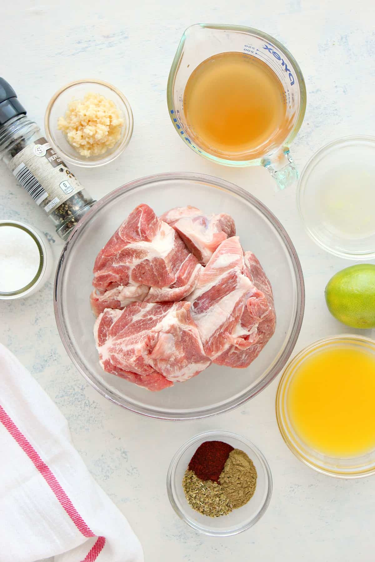 Ingredients for carnitas on a white board.