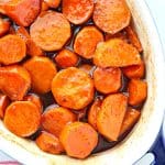 Candied cut sweet potatoes in a baking dish.