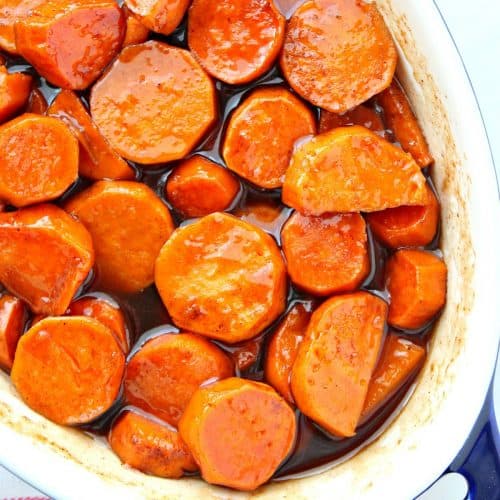 Sweet potatoes in brown sugar sauce in baking dish.
