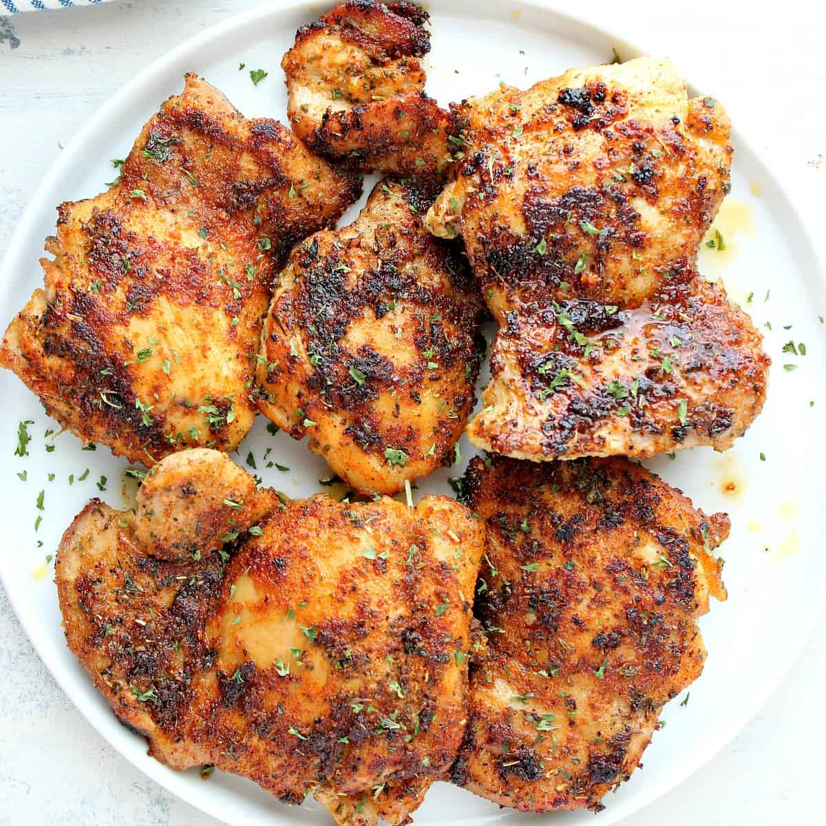 Chicken thighs on a plate.