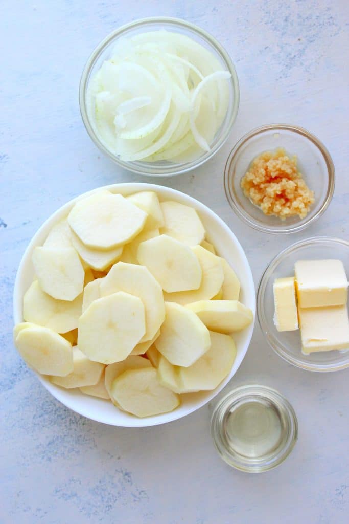 Ingredients for potatoes on a white board.