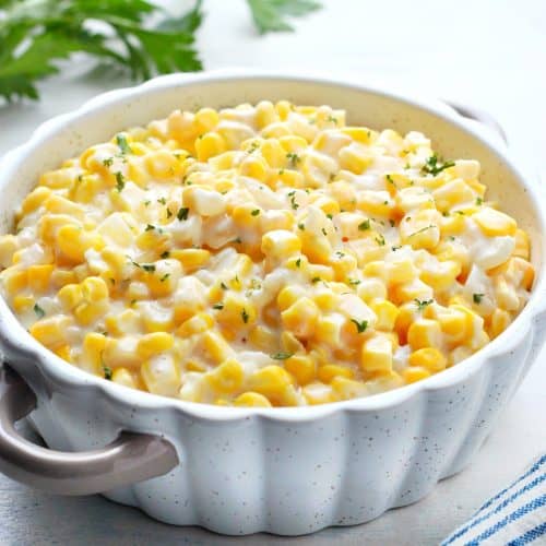 Corn in a creamy sauce in a dish.