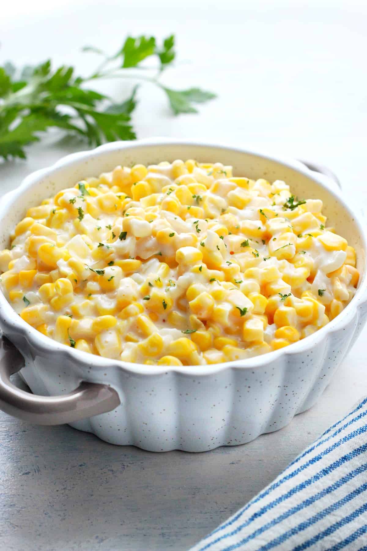 Corn in a creamy sauce in a dish.