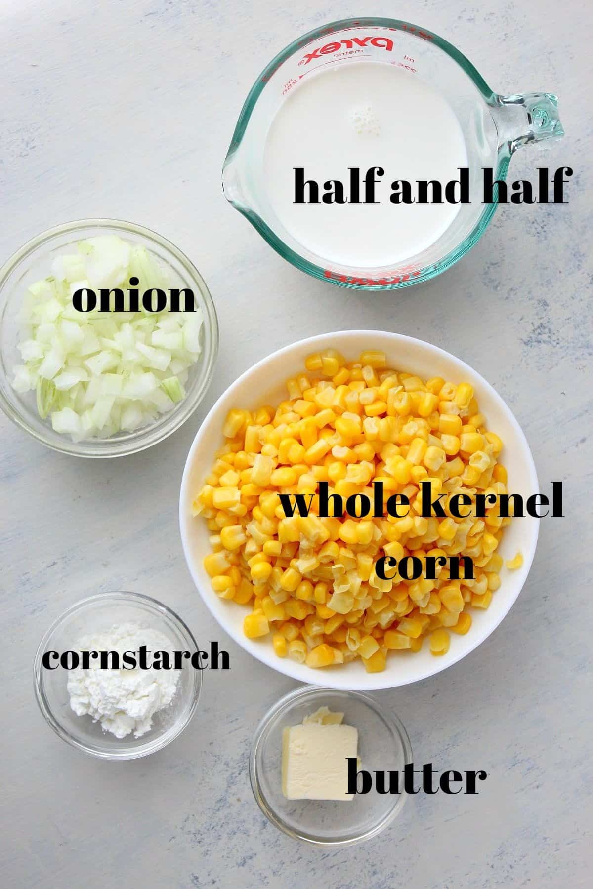 Ingredients for creamed corn on a board.