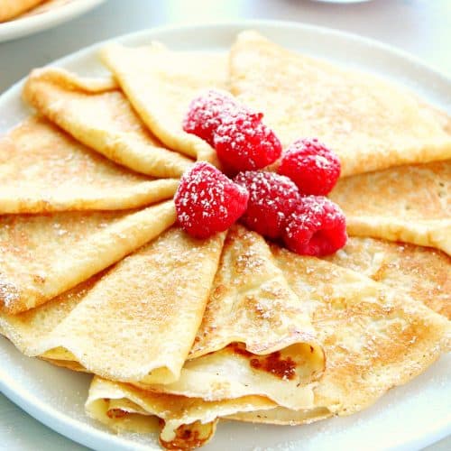 Crepes with berries on a plate.