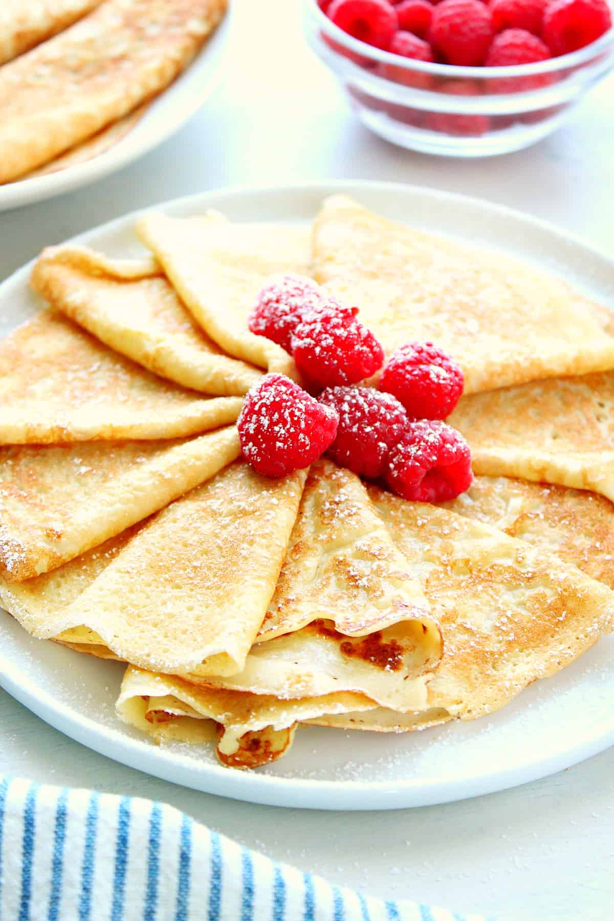 Crepes with berries on a plate.