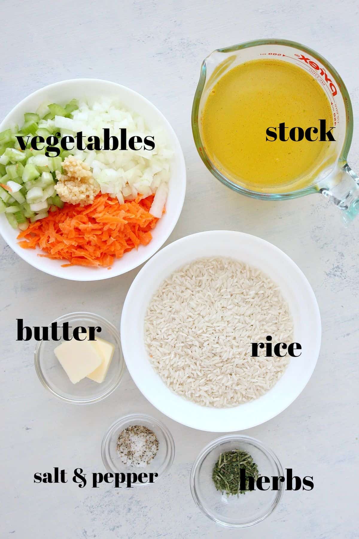 Ingredients for rice pilaf on a board.