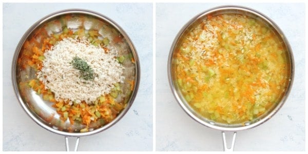 Veggies and rice with stock in a skillet.