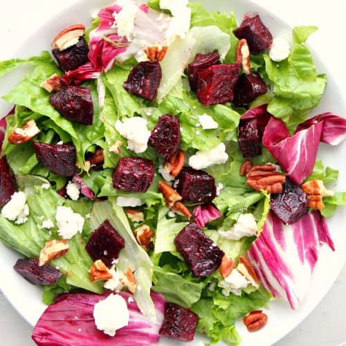 Salad with beets on a white plate.