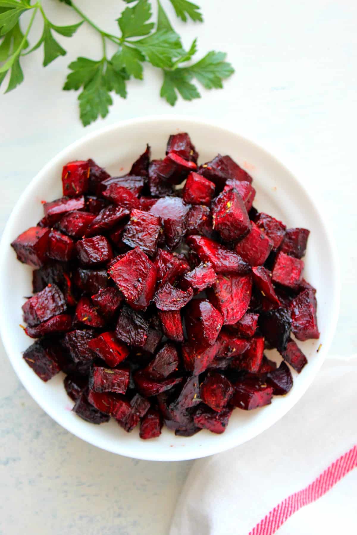 Roasted beets in a white bowl.