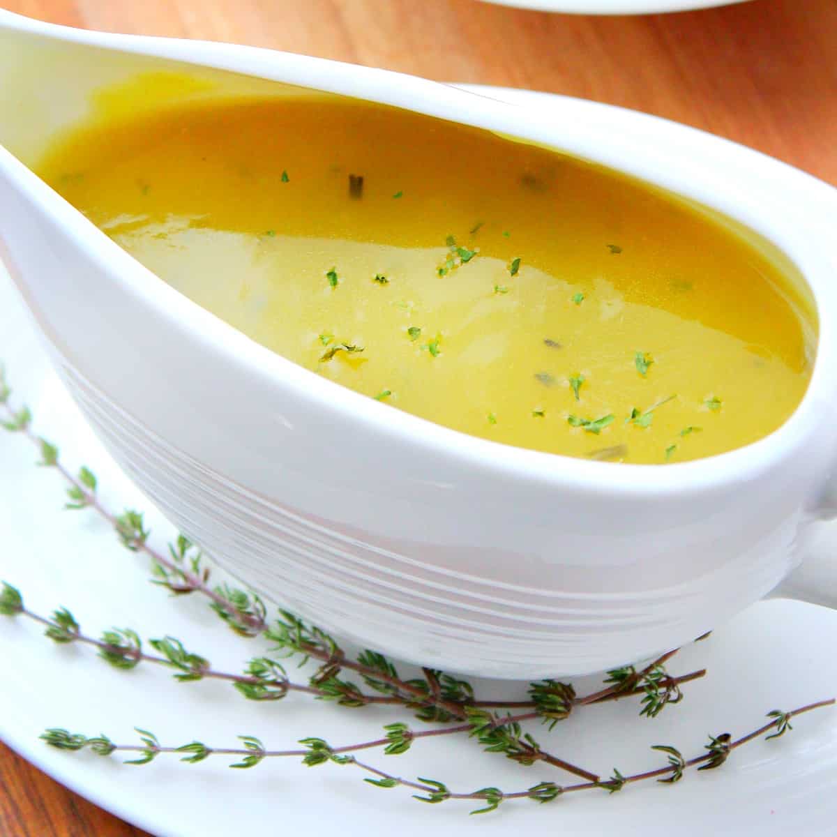 Turkey gravy in a white boat serving dish.