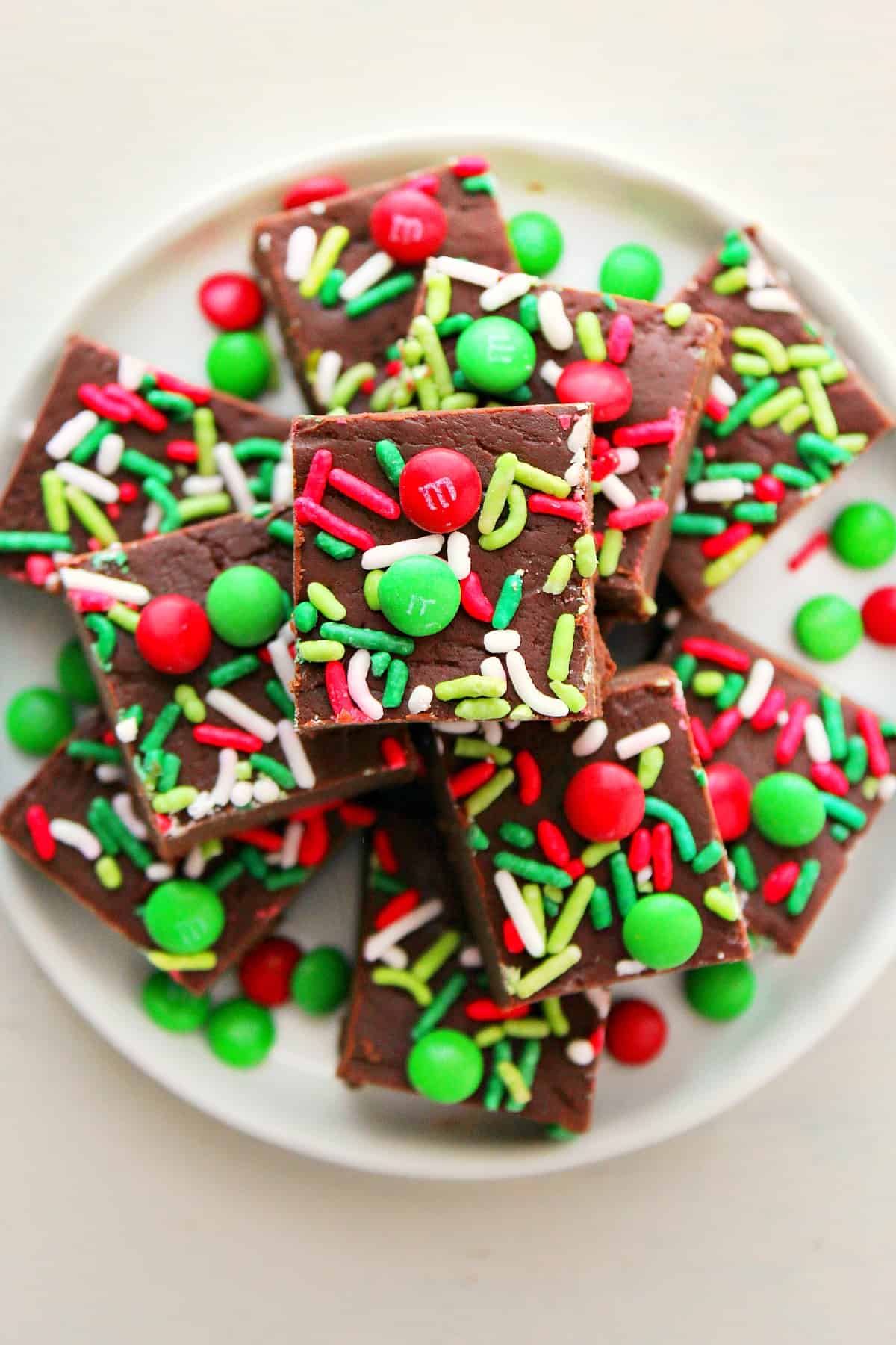 Christmas fudge with sprinkles on a plate.