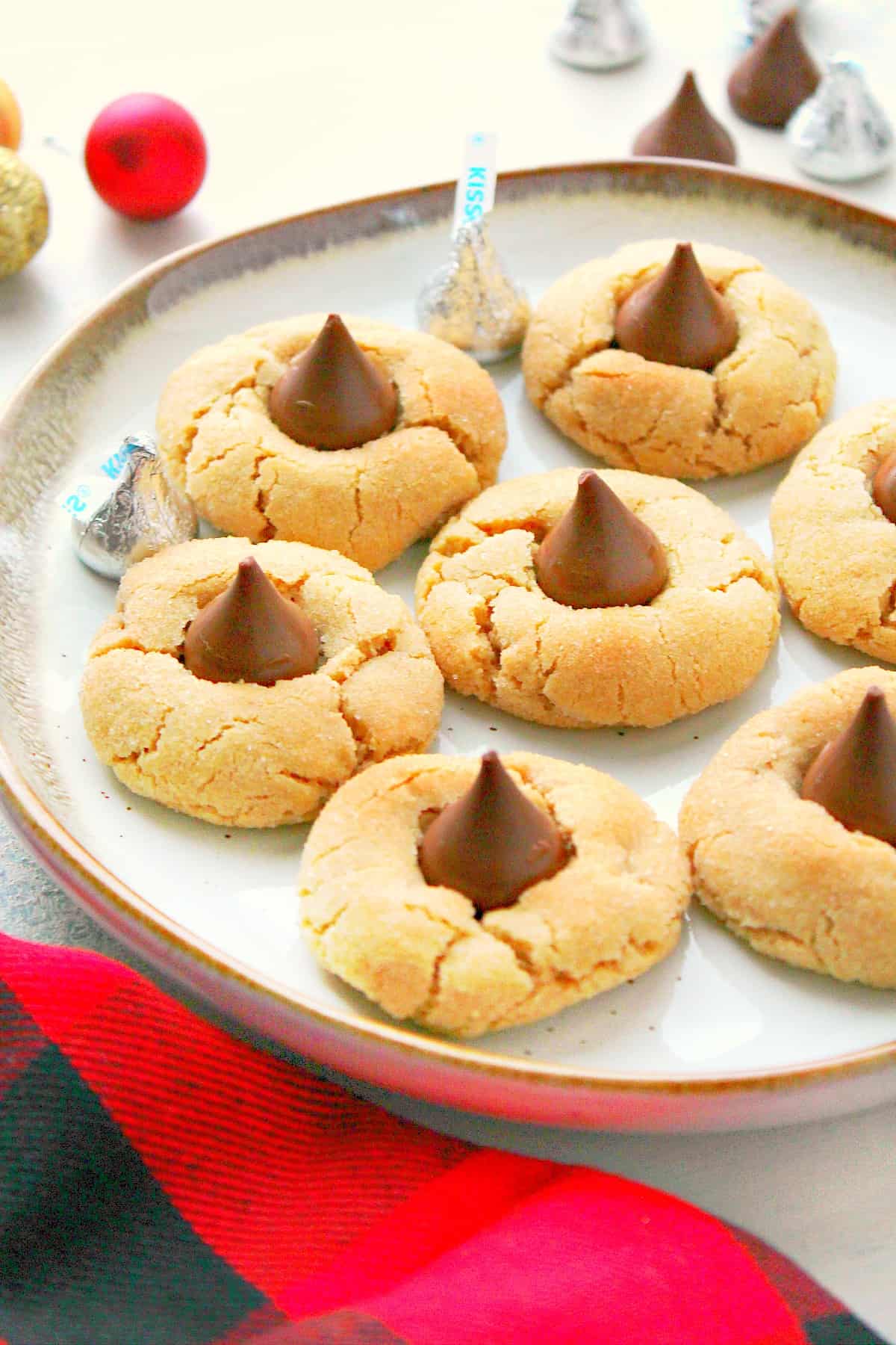 Peanut Butter Blossoms Cookies recipe Cookies with chocolate candy on a plate.