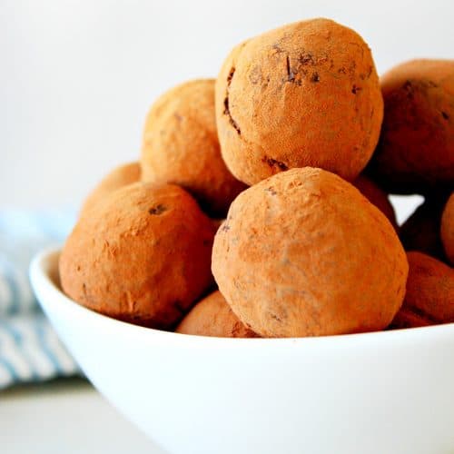 Chocolate truffles in a white bowl.