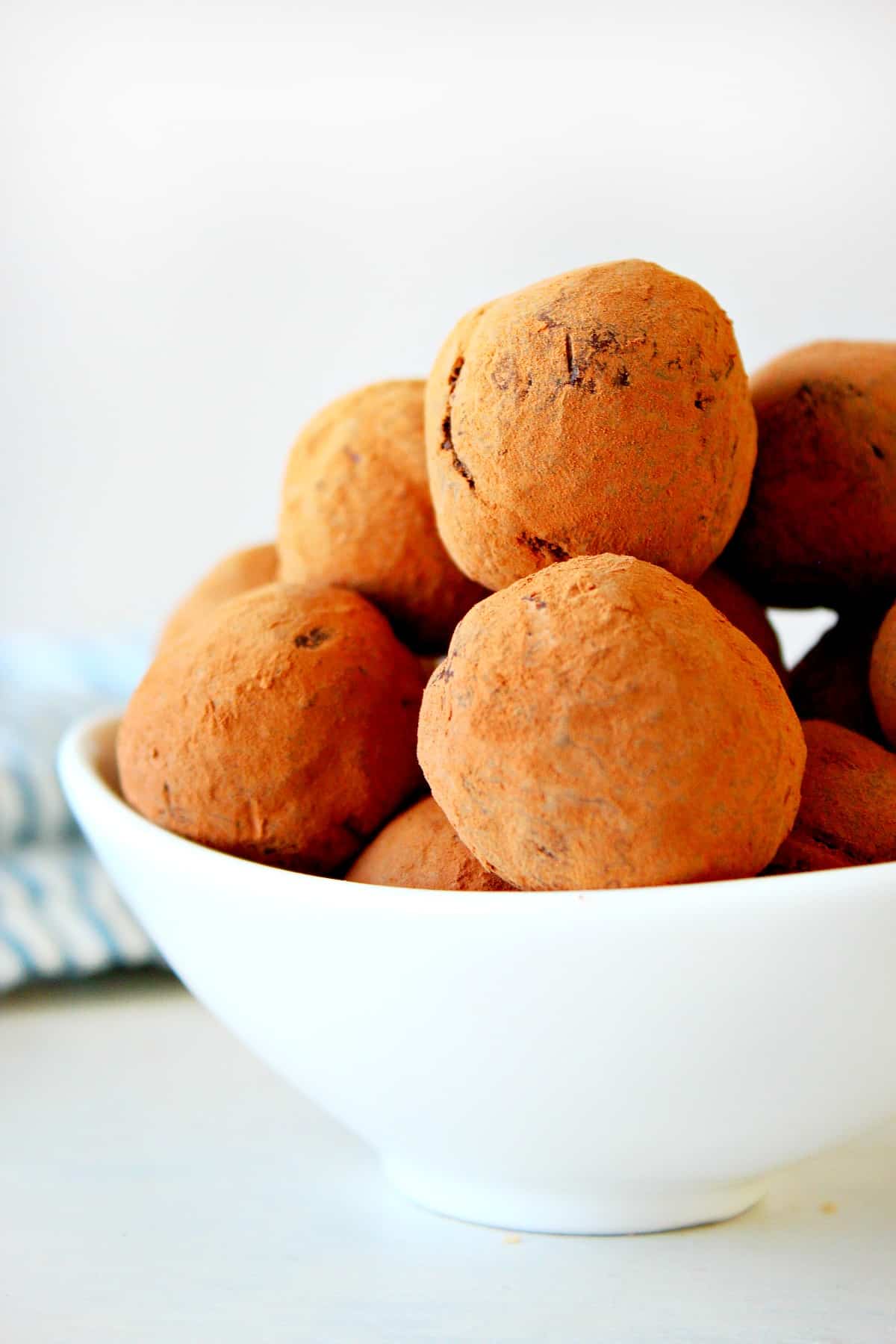Chocolate truffles in a white bowl.