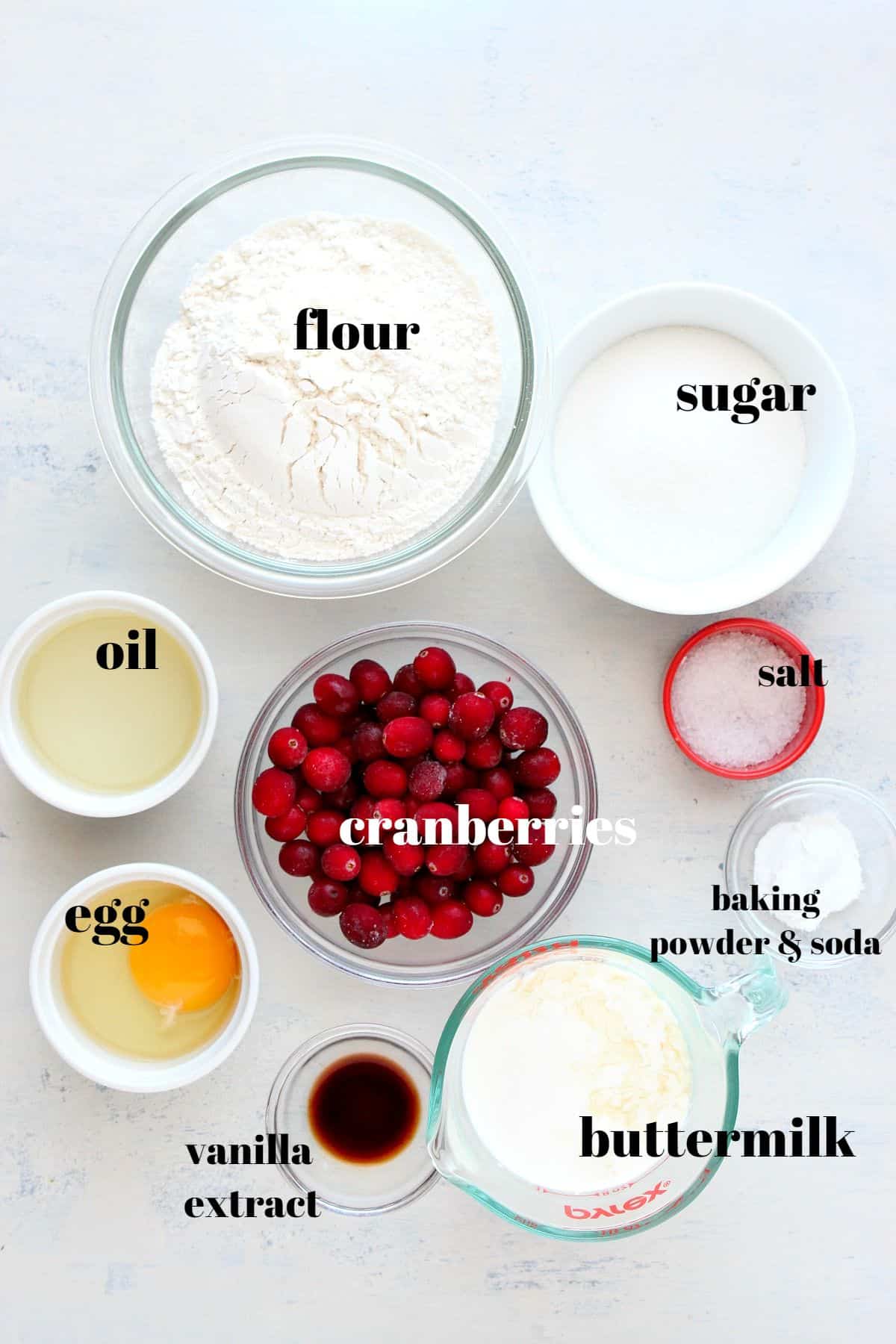 Ingredients for cranberry muffins on a board.