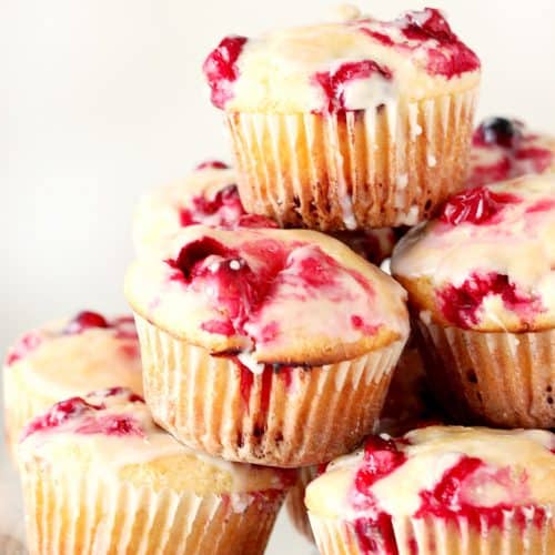 Cranberry muffins on glass stand.