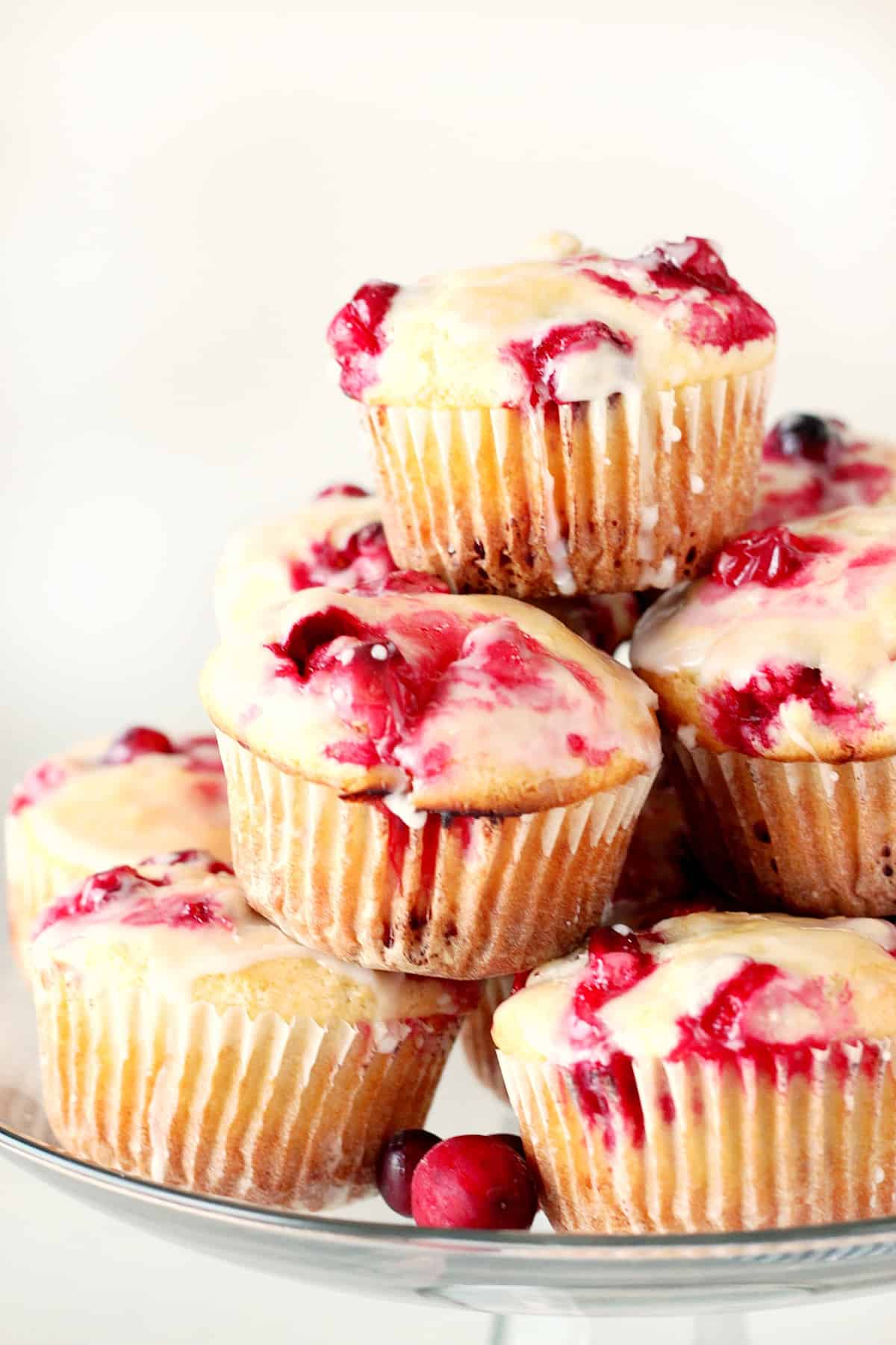 Cranberry muffins on glass stand.