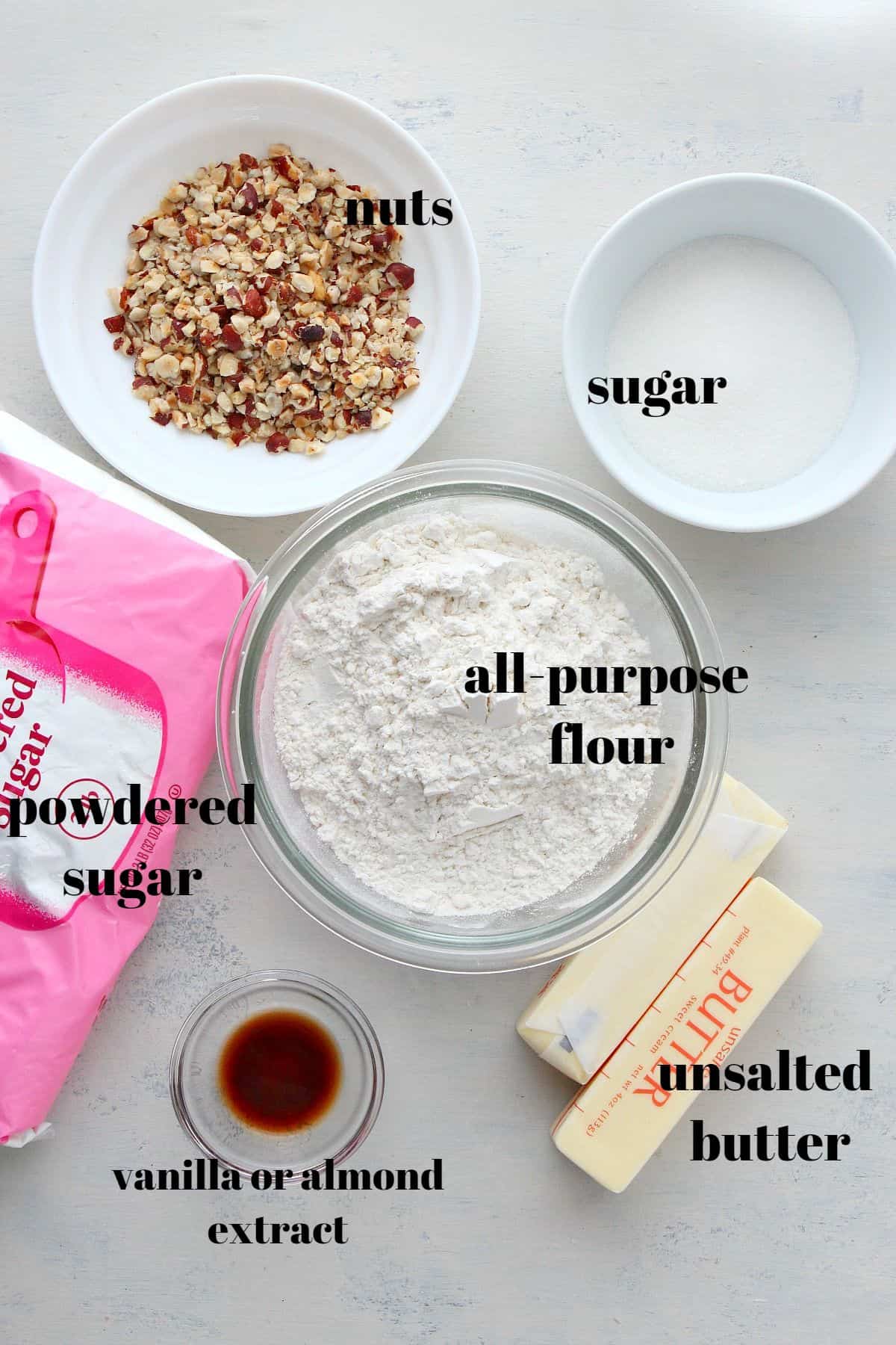 Ingredients for snowball cookies on a board.