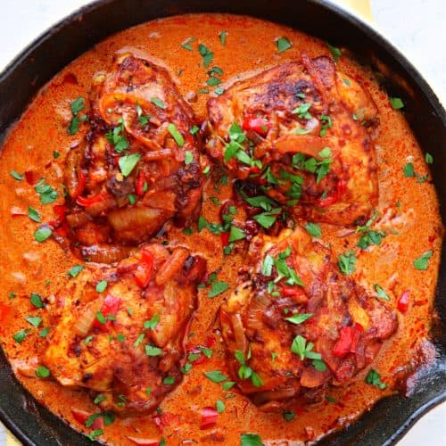 Chicken in paprika sauce in a skillet.