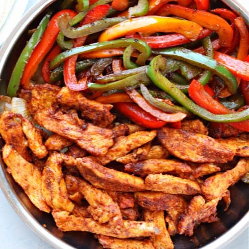 Chicken and peppers in skillet.