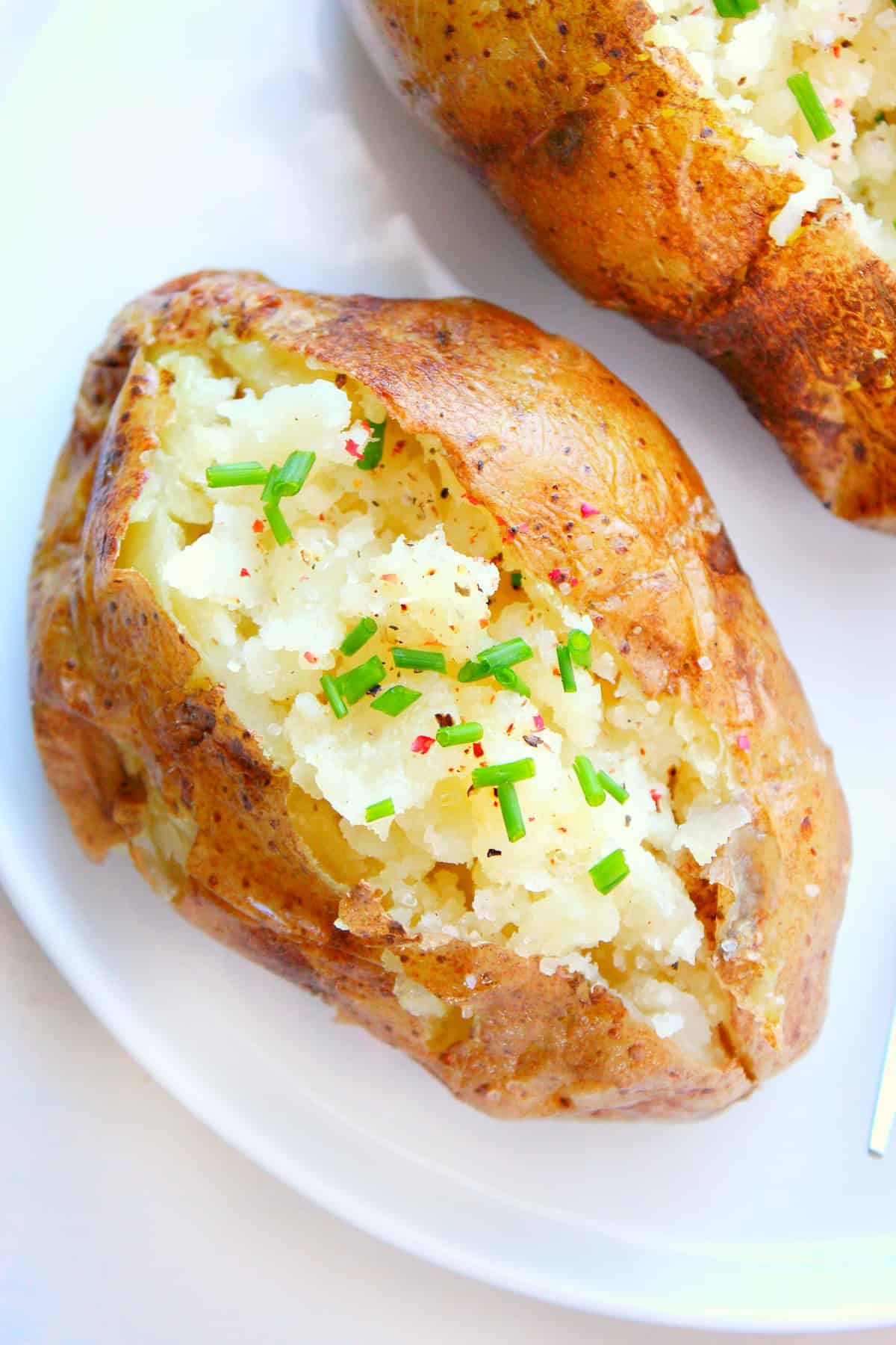 Sliced baked potato on a plate.