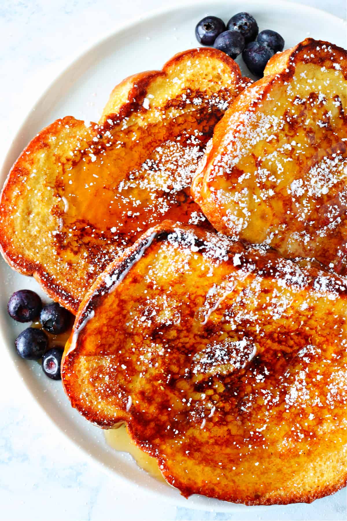 Three French toast slices on a plate.