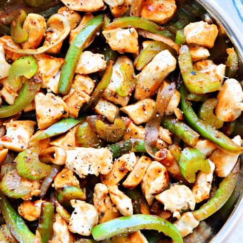 Chicken and vegetables in skillet.
