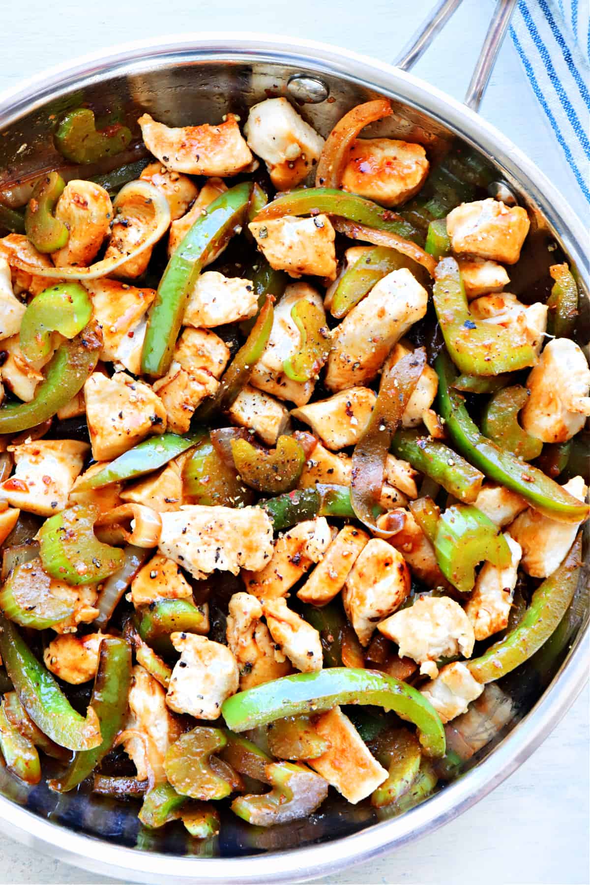 Chicken and vegetables in skillet.