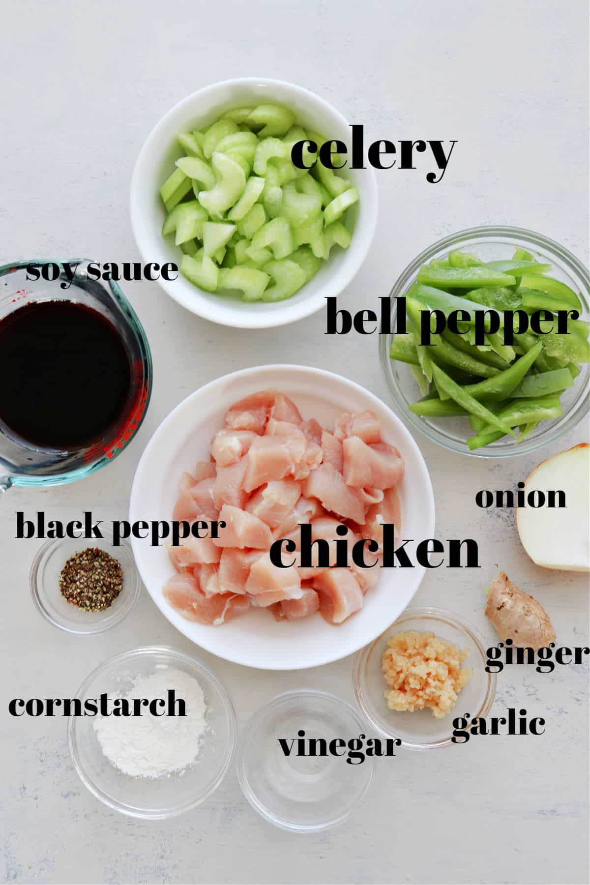 Ingredients for black pepper chicken on a board.