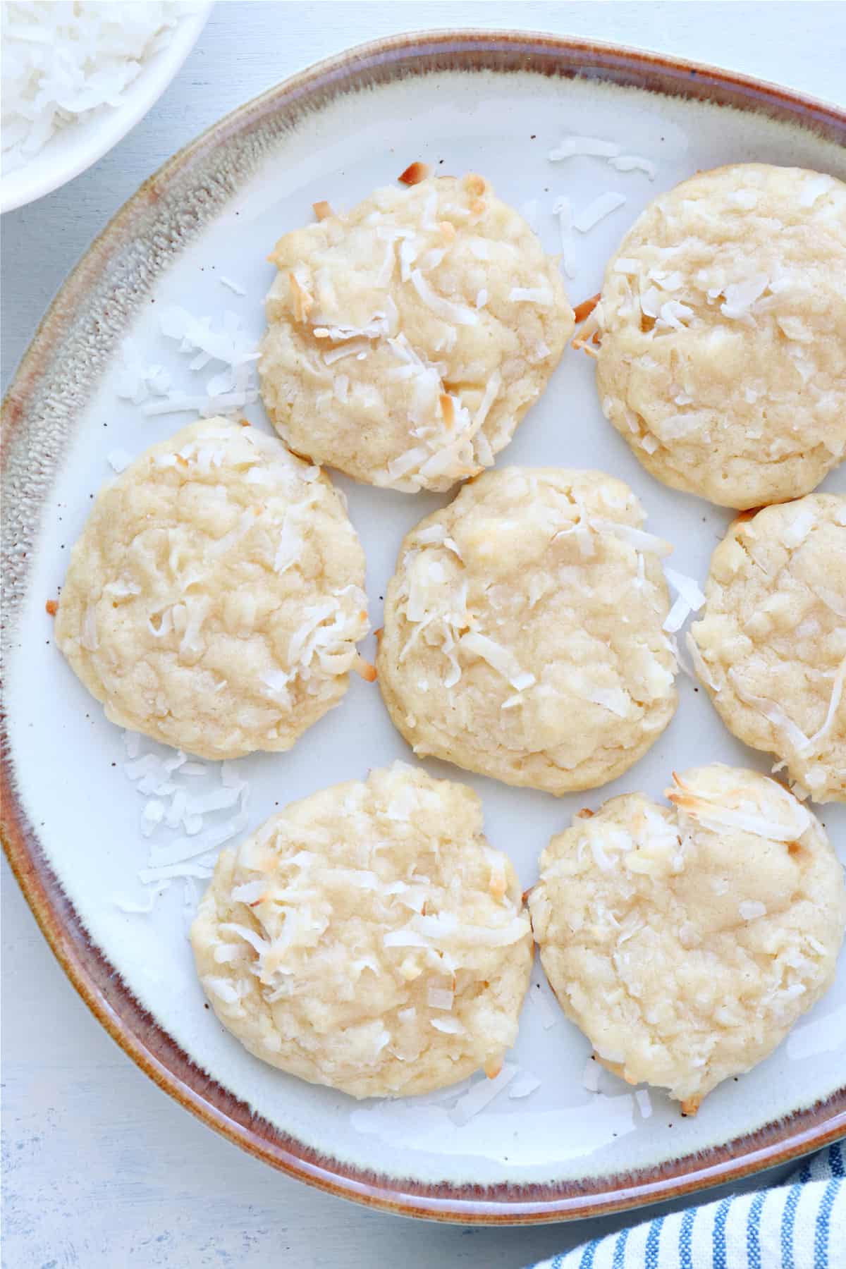 Cookies with coconut on a plate with rim.