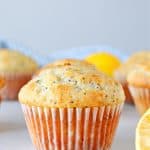 Lemon muffin with poppy seeds on a board.