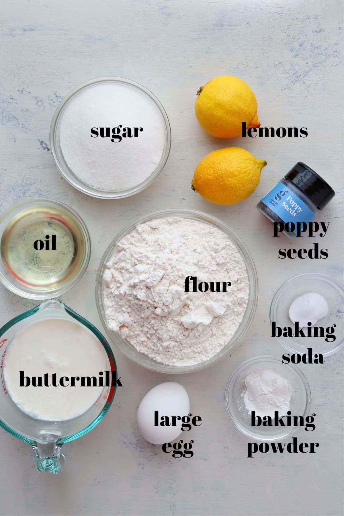 Ingredients for poppy seed muffins on a board.