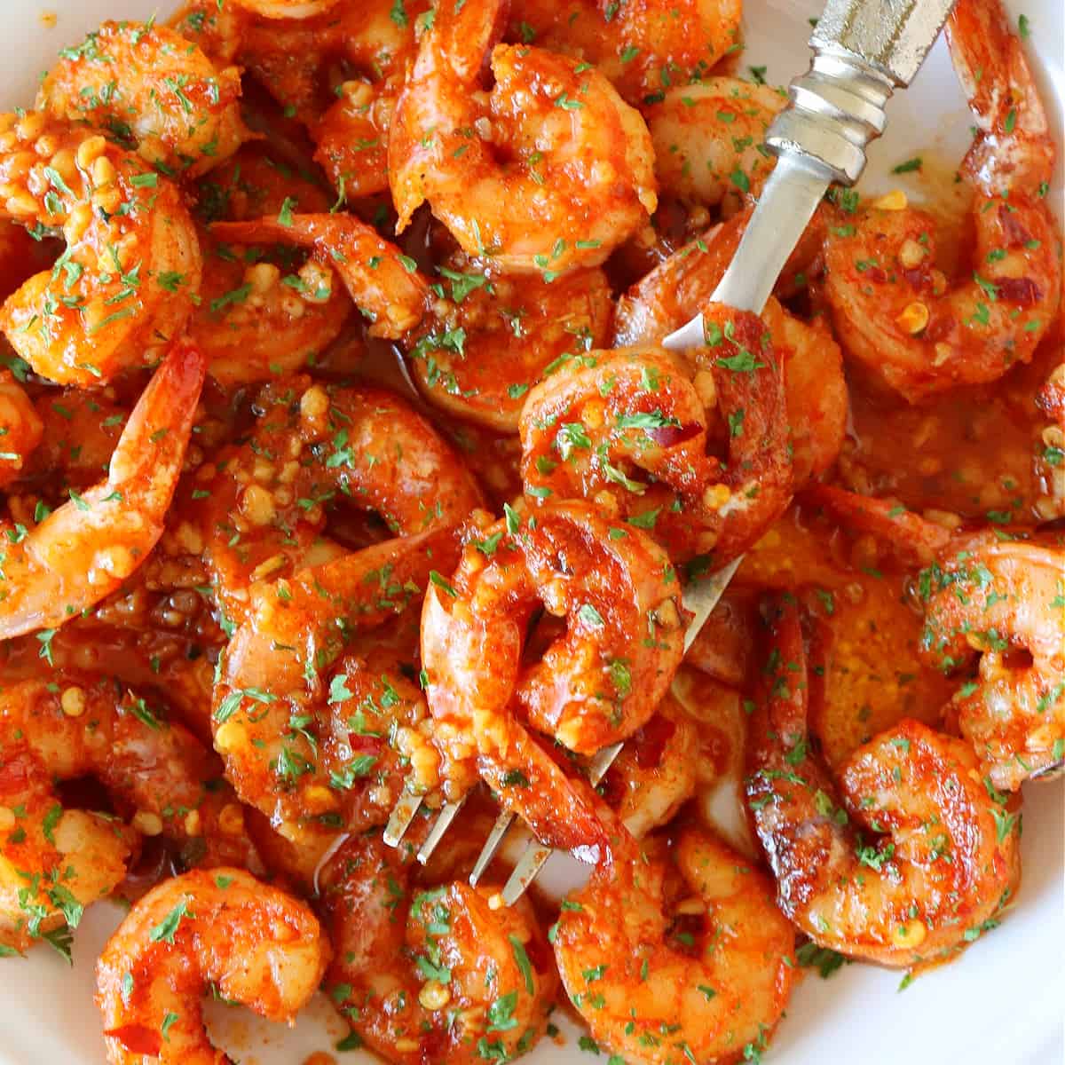 Cajun shrimp on a white dish.