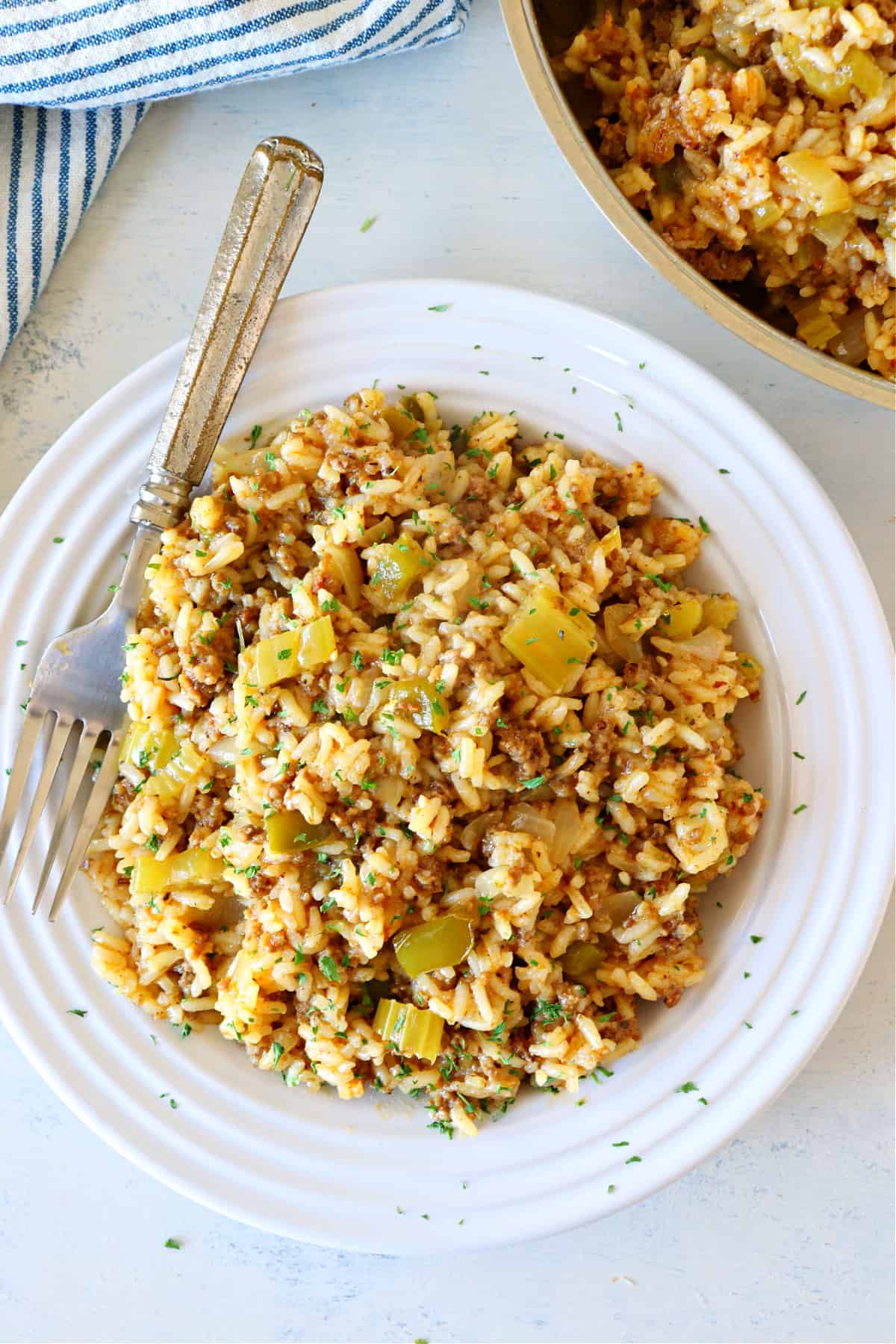 Dirty rice in a white bowl.