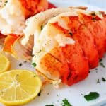 Two lobster tails on a plate.