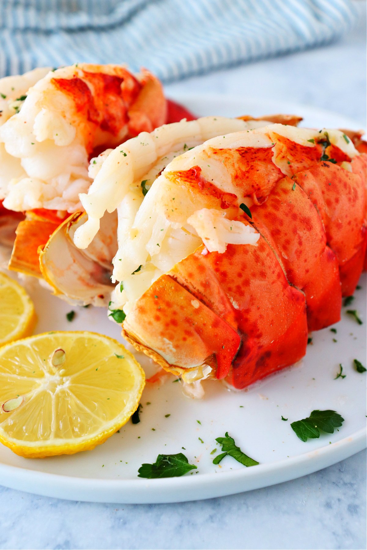 Two lobster tails on a plate.