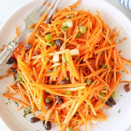 Carrot salad on a plate with fork.