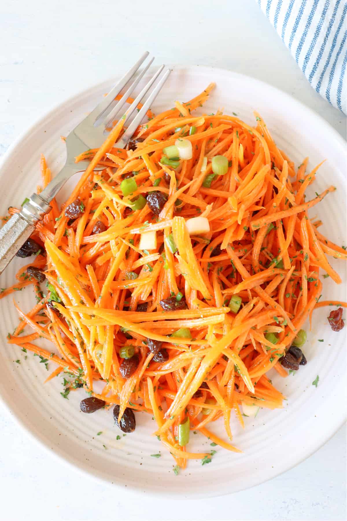 Carrot Salad Recipe Carrot salad on a plate with fork.