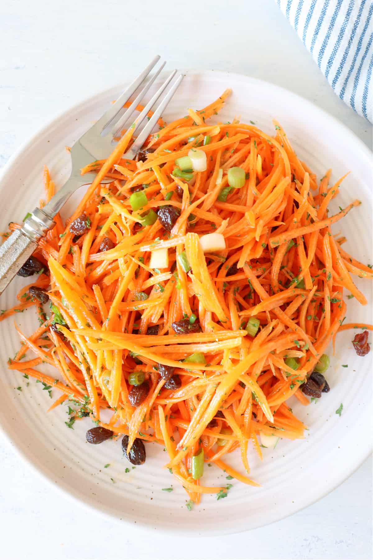 Carrot salad on a plate with fork.