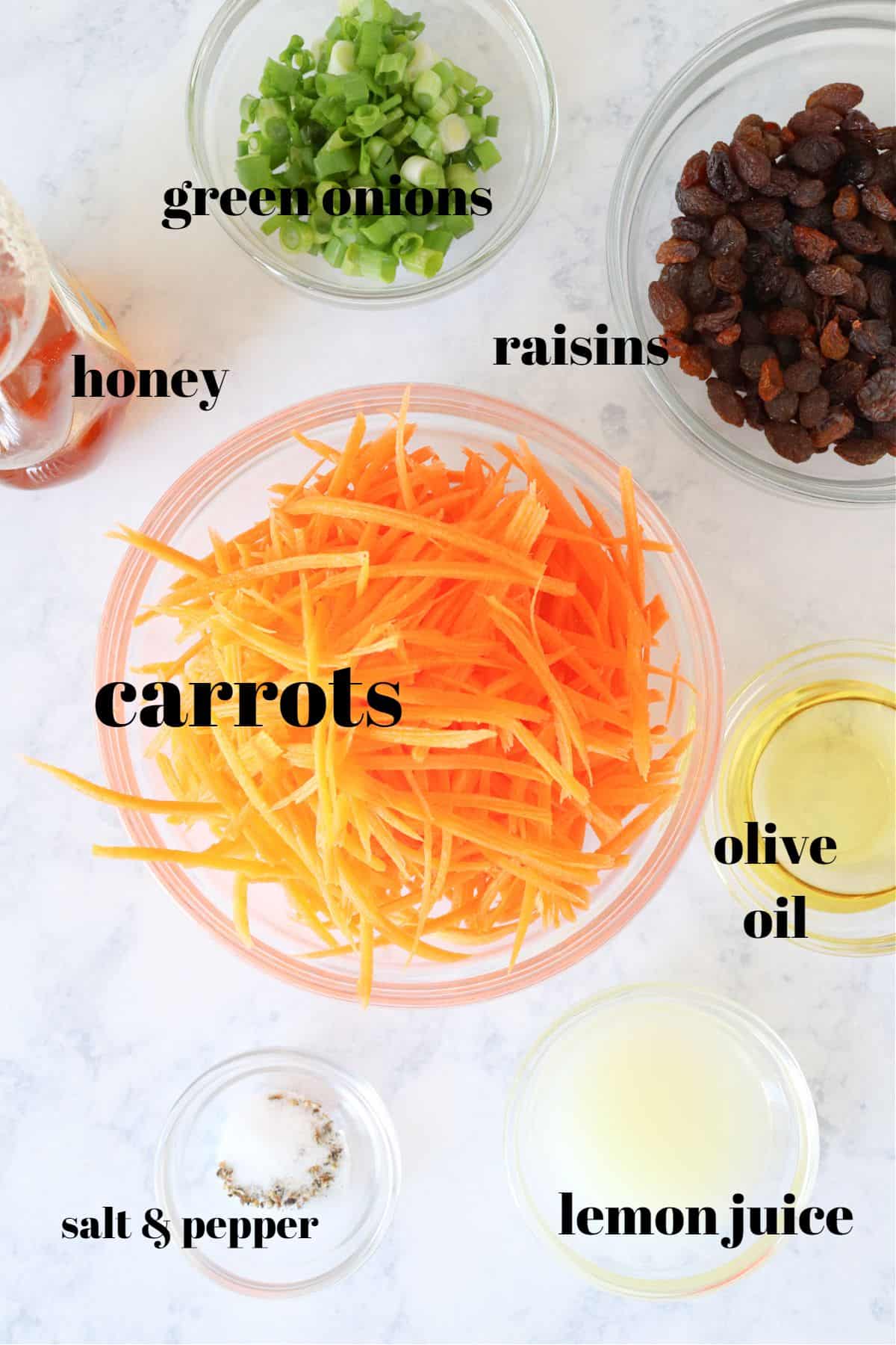 Ingredients for carrot salad on a marble board.