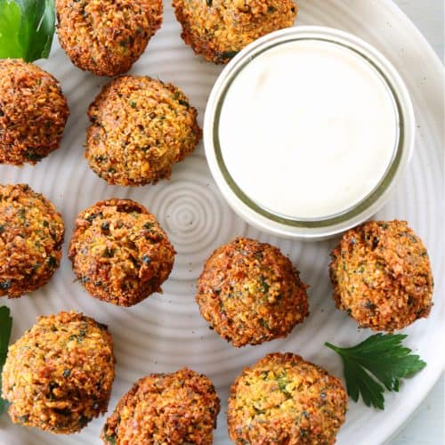 Fried falafel with sauce on a plate.
